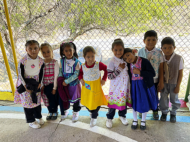 Kids proudly showing off their new clothes